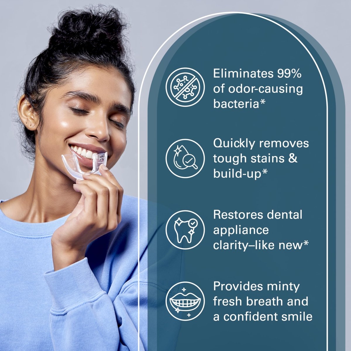 Woman holding a dental device with cleaning tablet features for removing stains and build-up for a confident smile.