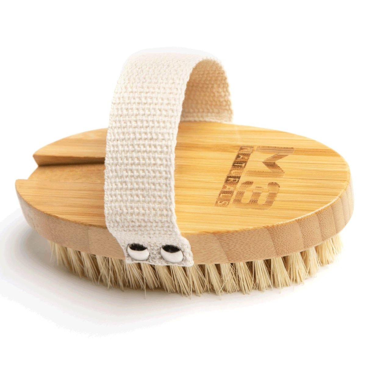 Dry body brush with wooden handle and nylon strap on a white background