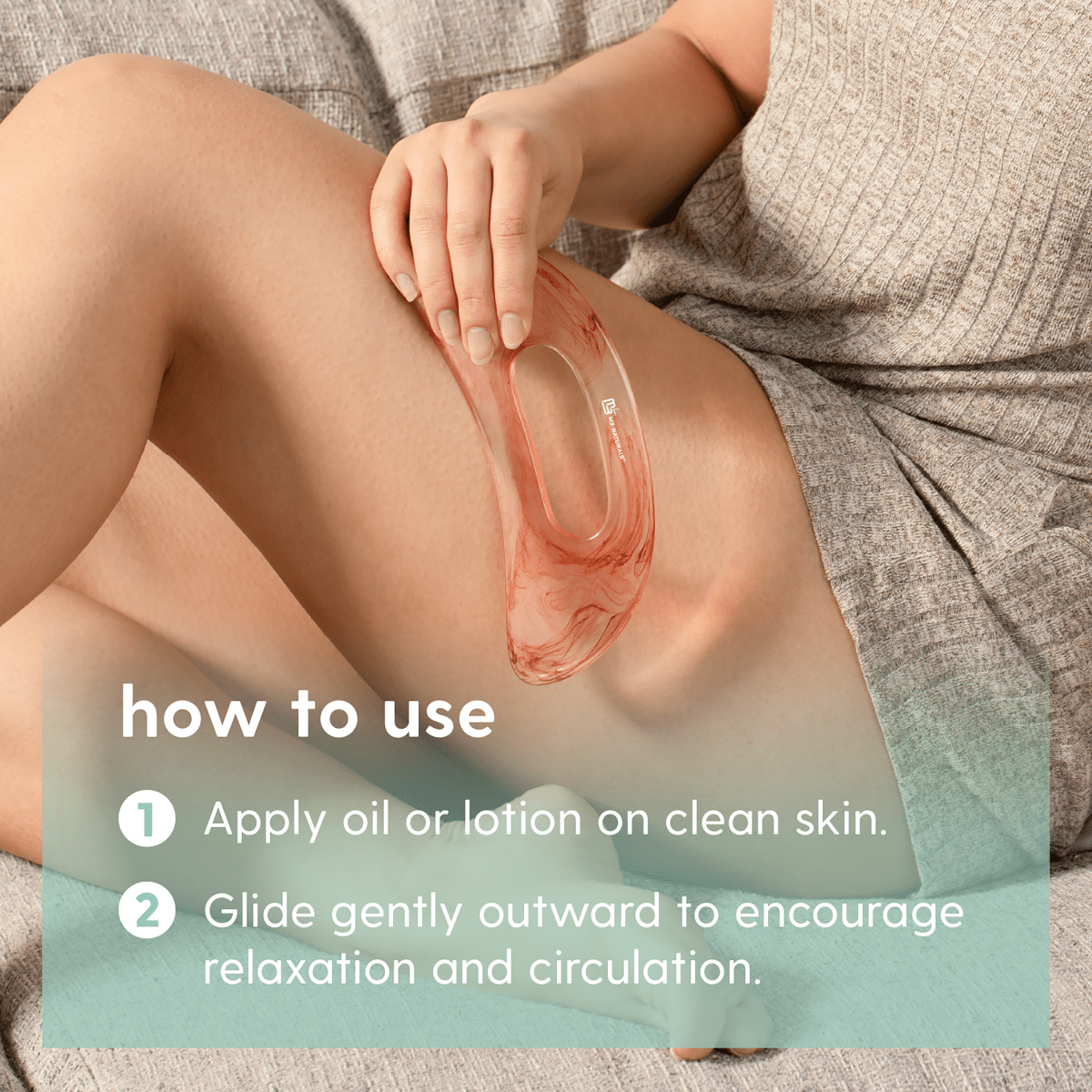 Woman using gua sha on leg with instructions on how to use it