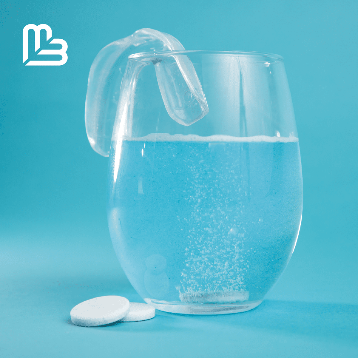 Dental device on a clear glass with water and cleaning tablets on a blue background