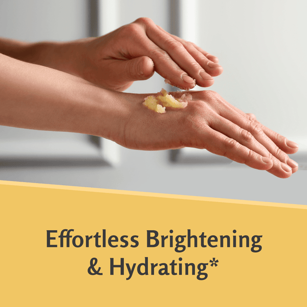 Person applying turmeric scrub to hands to demonstrate brightening and hydrating effect. 